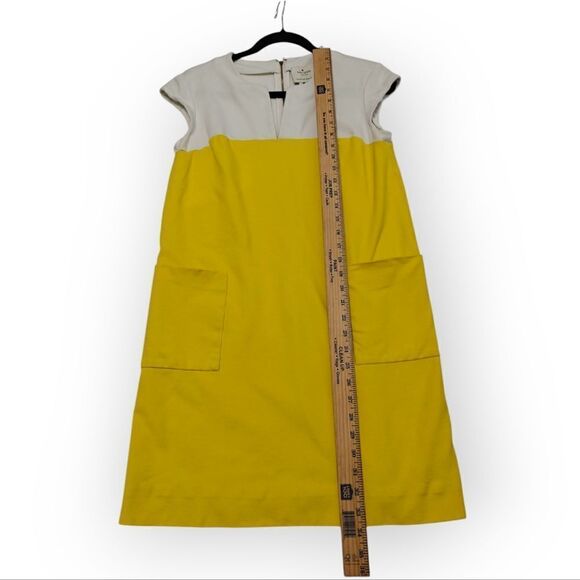 ケイト・スペードの黄色のAラインのラグランの帽子の袖のポケットSz S 